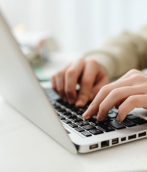 Hands typing on a laptop - tech and systems setup for women in business UK